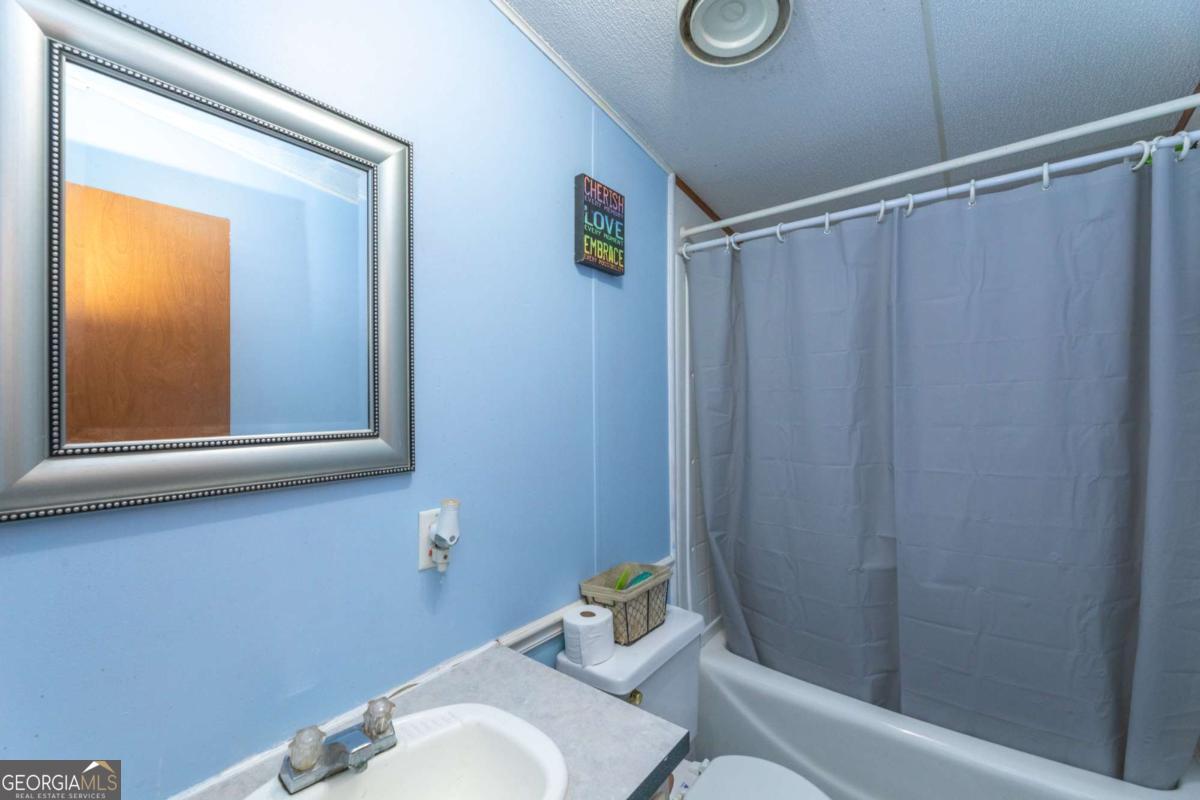 3547 Chapel Lane Blackshear, GA 31516 - Photo 21 of 33 a bathroom with a sink and a mirror