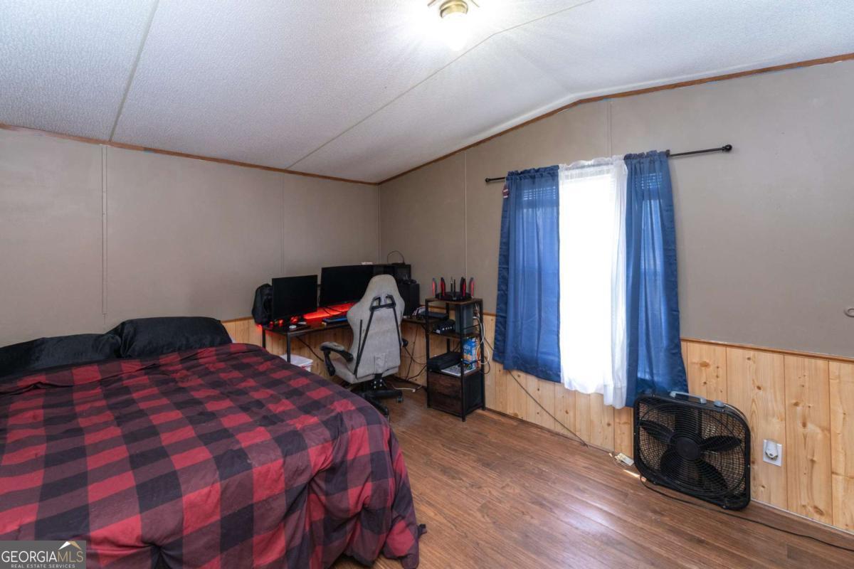 3547 Chapel Lane Blackshear, GA 31516 - Photo 22 of 33 a bedroom with a bed and a tv on the dresser