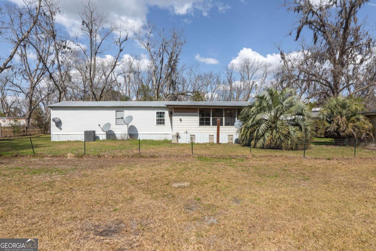 3547 Chapel Lane Blackshear, GA 31516 - Photo 27 of 33 a view of a house with backyard and trees