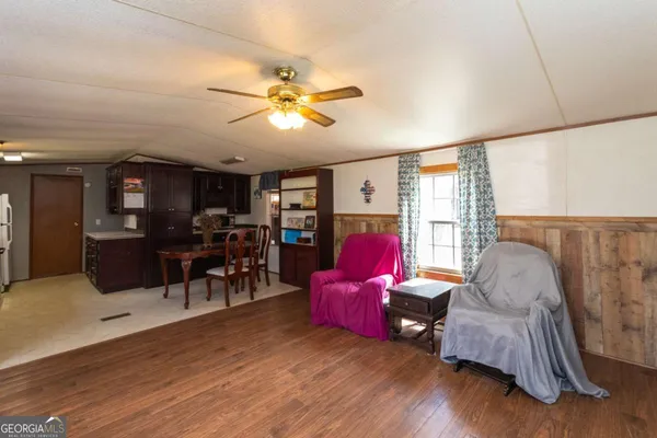 a living room with furniture flat screen tv and wooden floor