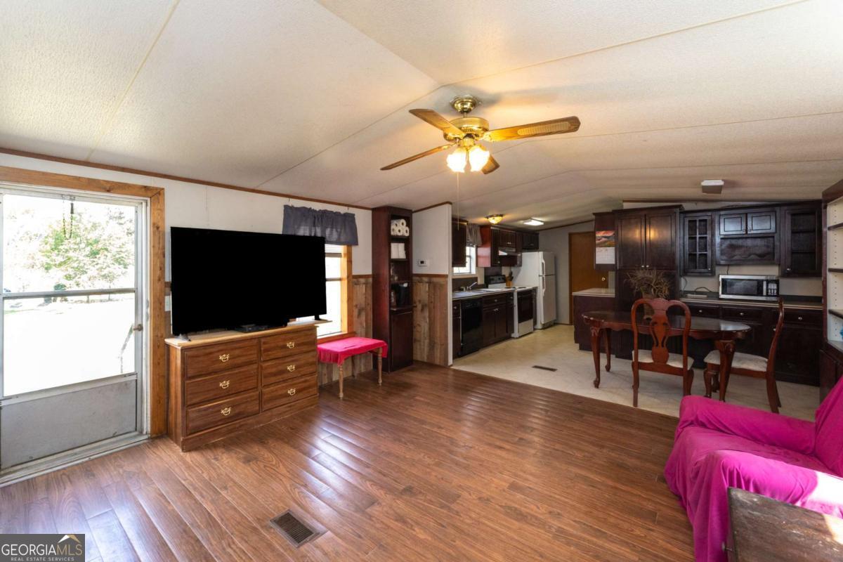 3547 Chapel Lane Blackshear, GA 31516 - Photo 7 of 33 a living room with furniture flat screen tv and wooden floor