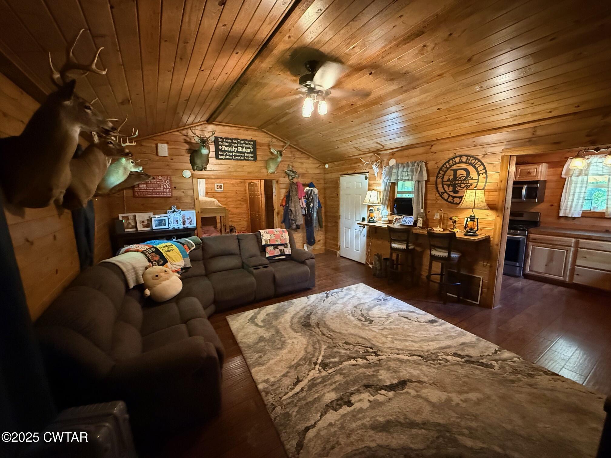 972 Cleve Duke Road Hornbeak, TN 38232 - Photo 15 of 36 a living room with furniture and a flat screen tv