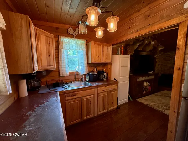 a kitchen with stainless steel appliances granite countertop a stove a refrigerator and a microwave