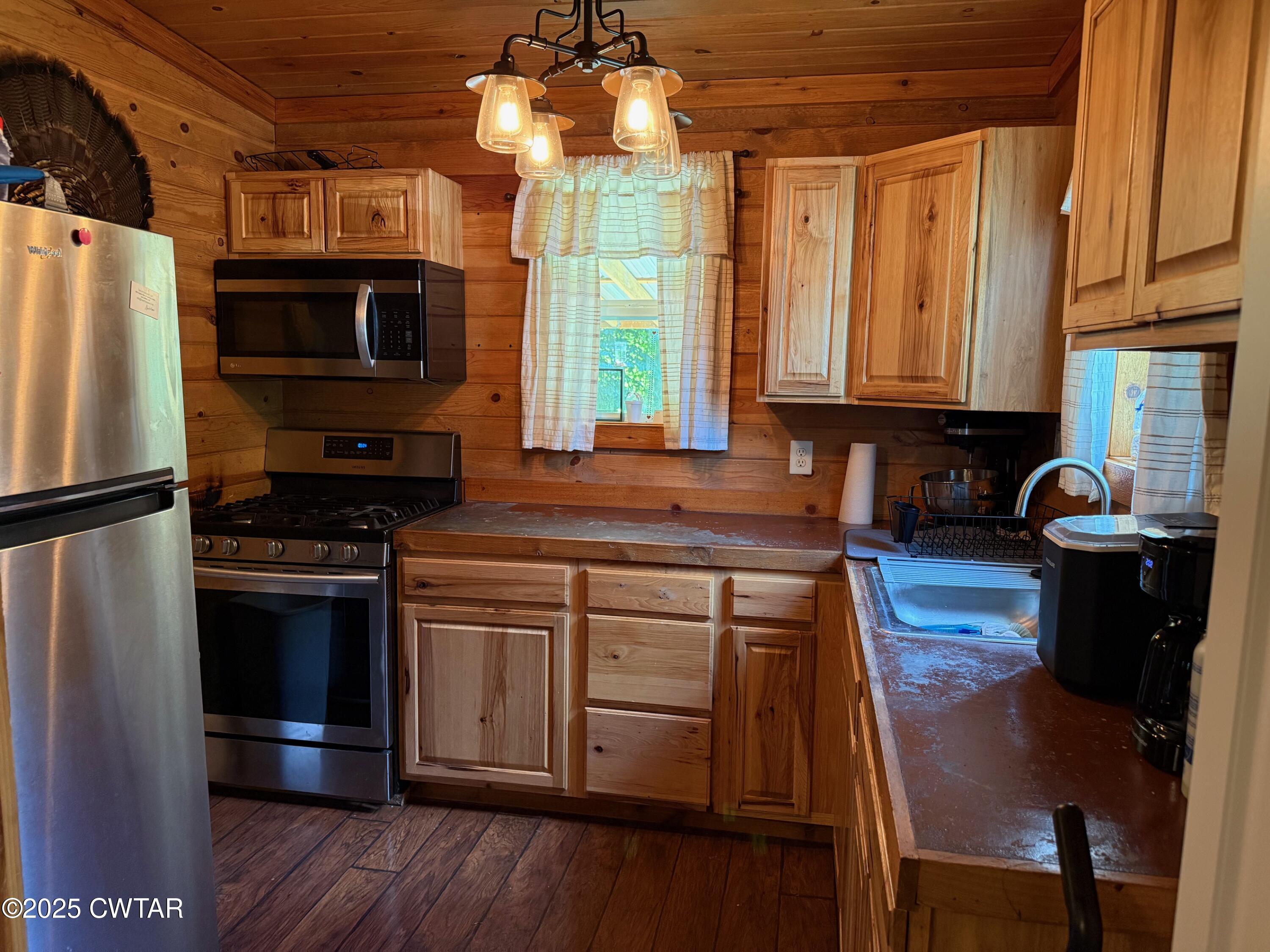 972 Cleve Duke Road Hornbeak, TN 38232 - Photo 17 of 36 a kitchen with stainless steel appliances granite countertop a stove a refrigerator and a microwave