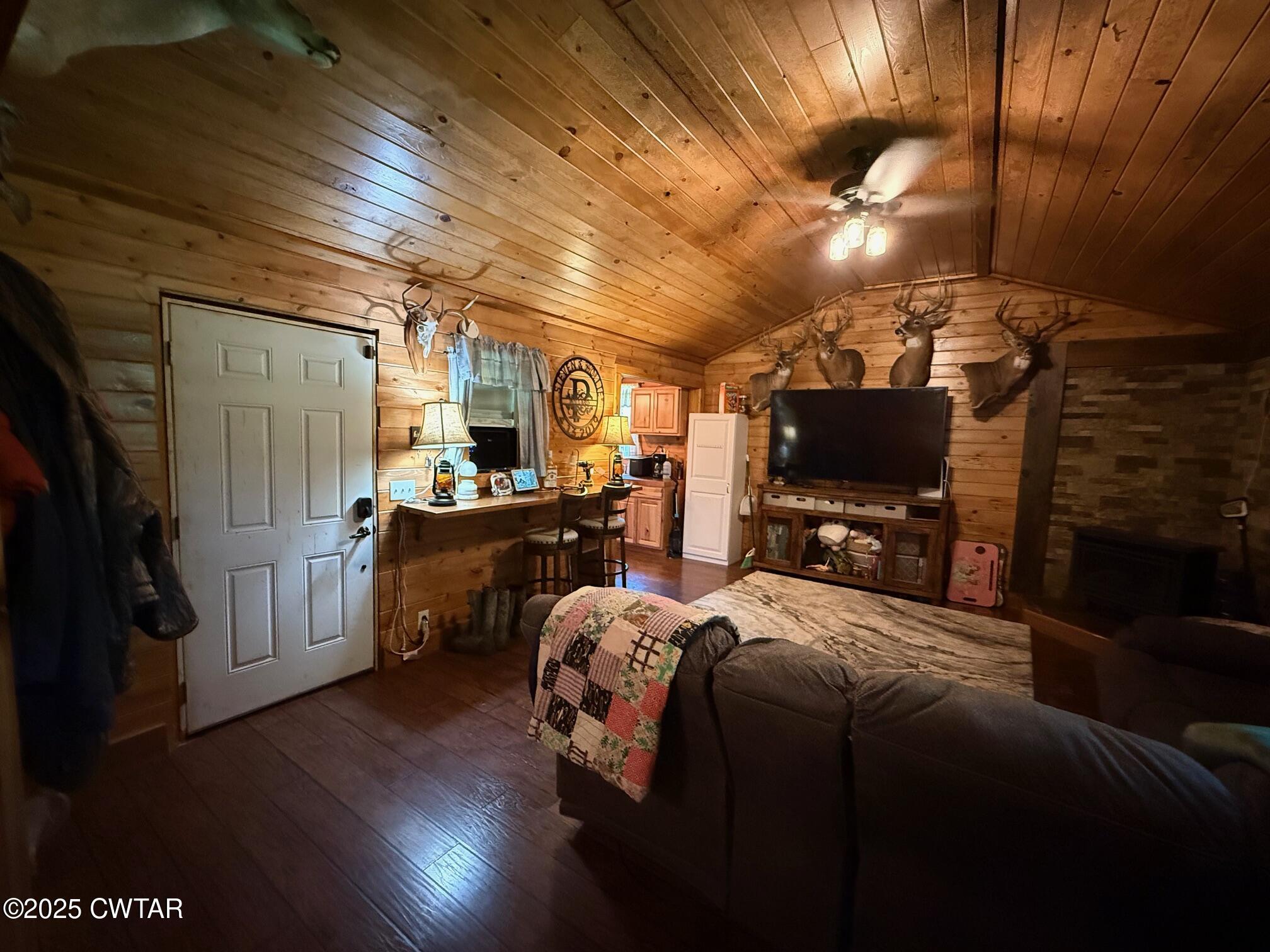 972 Cleve Duke Road Hornbeak, TN 38232 - Photo 3 of 36 a bedroom with furniture and a flat screen tv