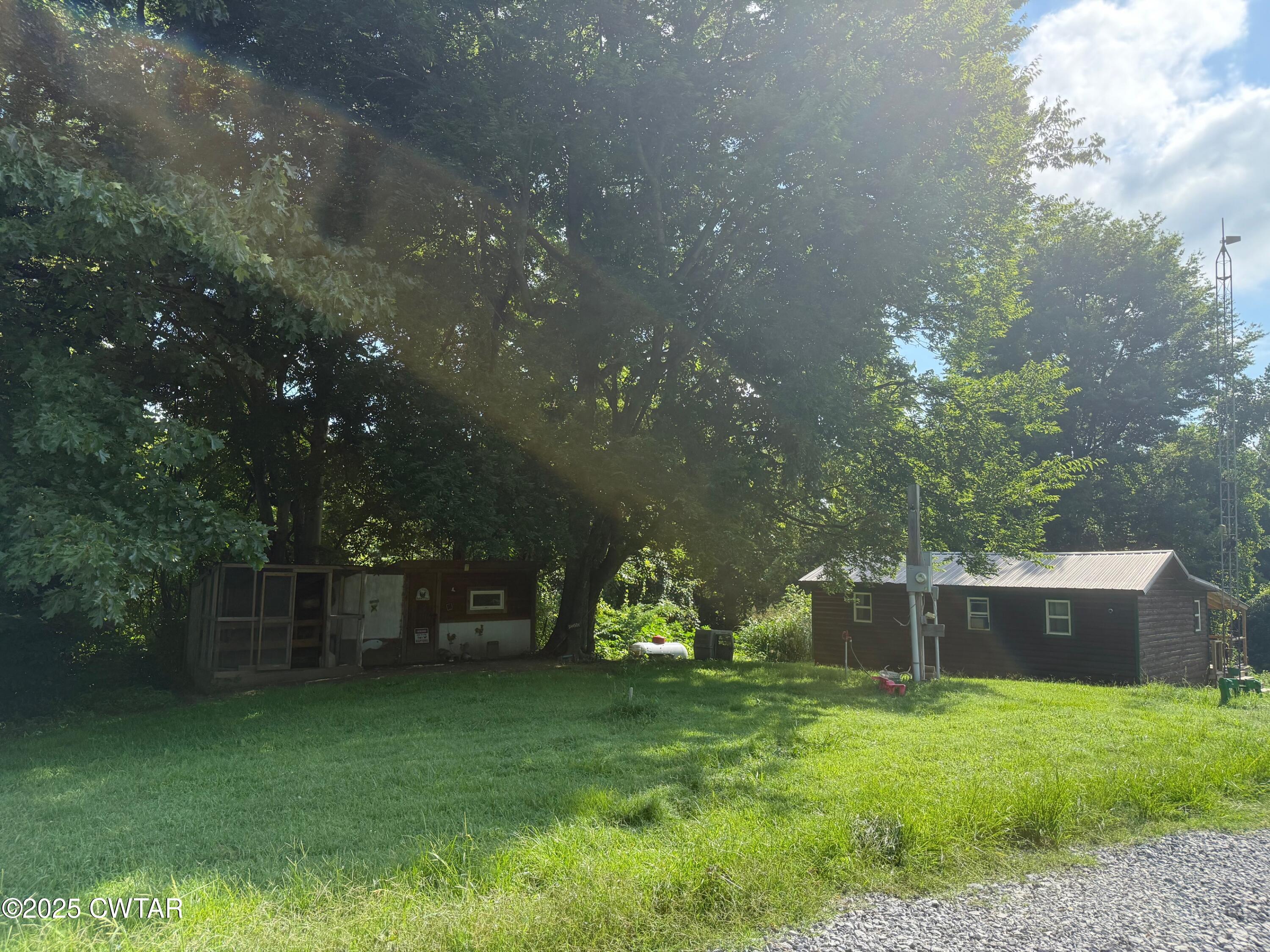 972 Cleve Duke Road Hornbeak, TN 38232 - Photo 31 of 36 a backyard of a house with lots of green space and fountain