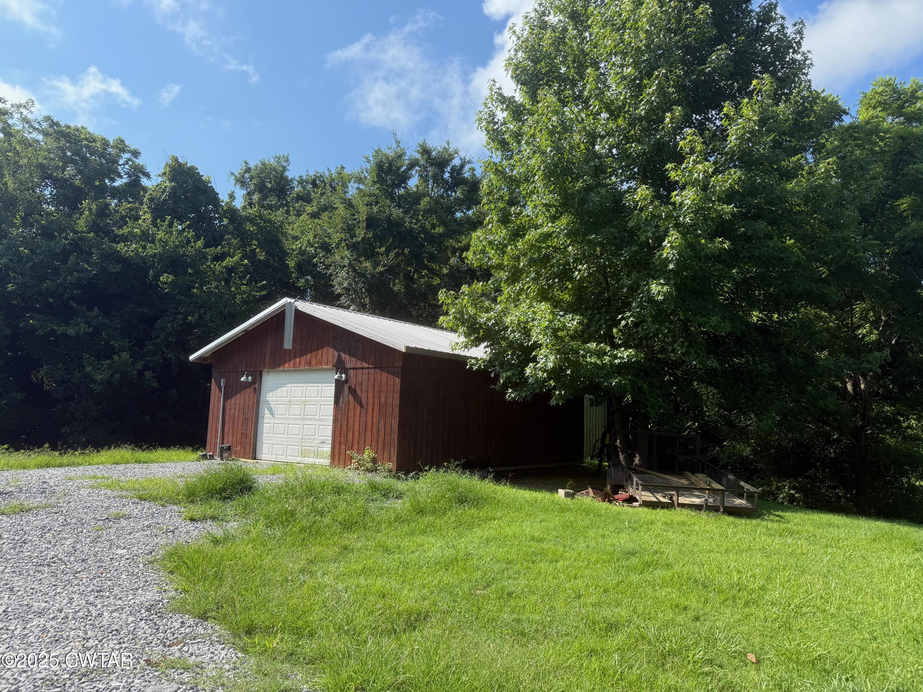 972 Cleve Duke Road Hornbeak, TN 38232 - Photo 32 of 36 a house with trees in the background