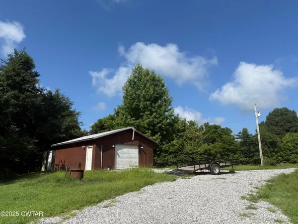 a view of a grassy field with trees