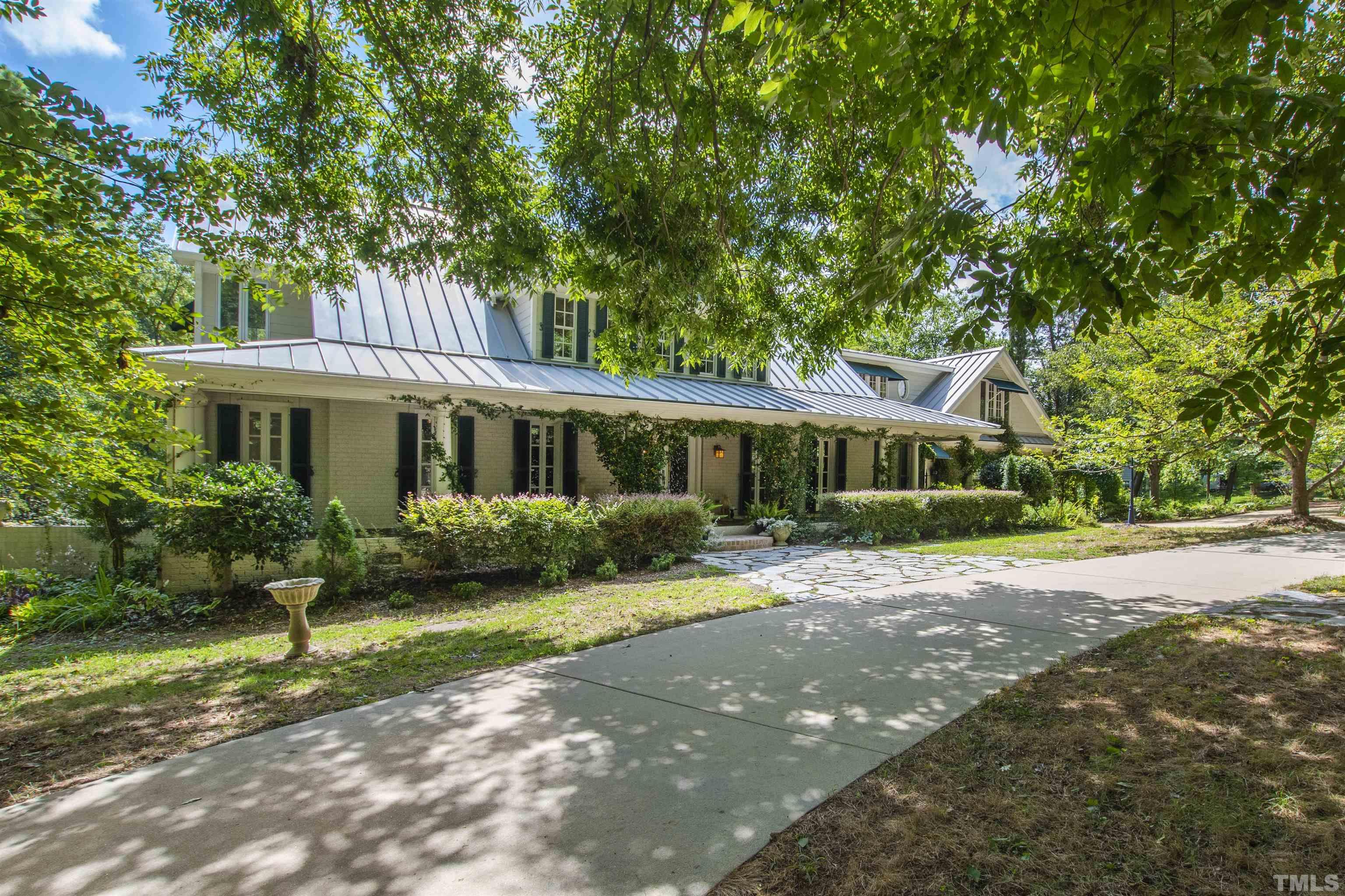 2429 Kirks Ridge Drive Raleigh, NC 27606 - Photo 16 of 65 a front view of a house with garden