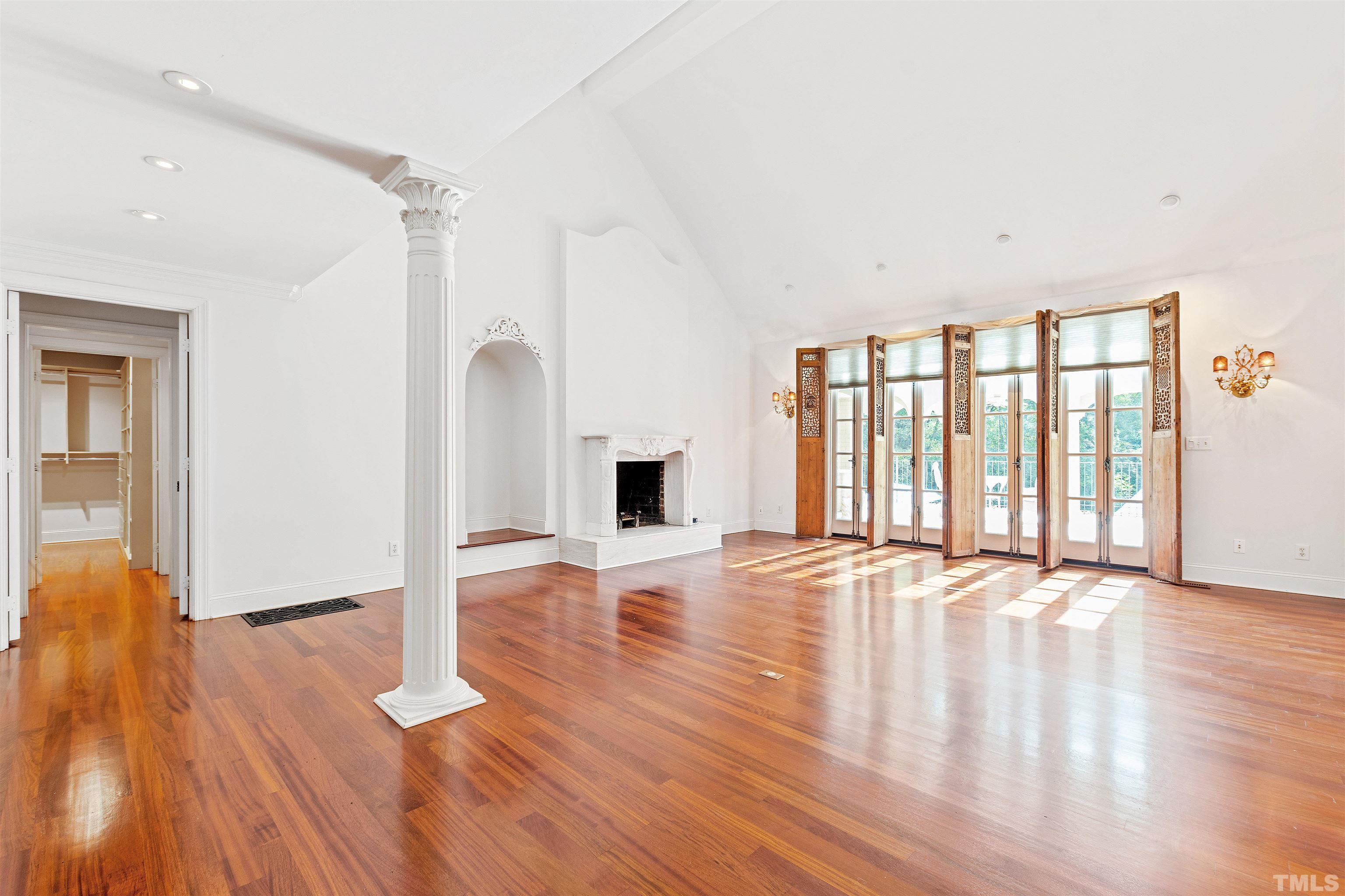 2429 Kirks Ridge Drive Raleigh, NC 27606 - Photo 23 of 65 a view of an empty room with wooden floor and a window