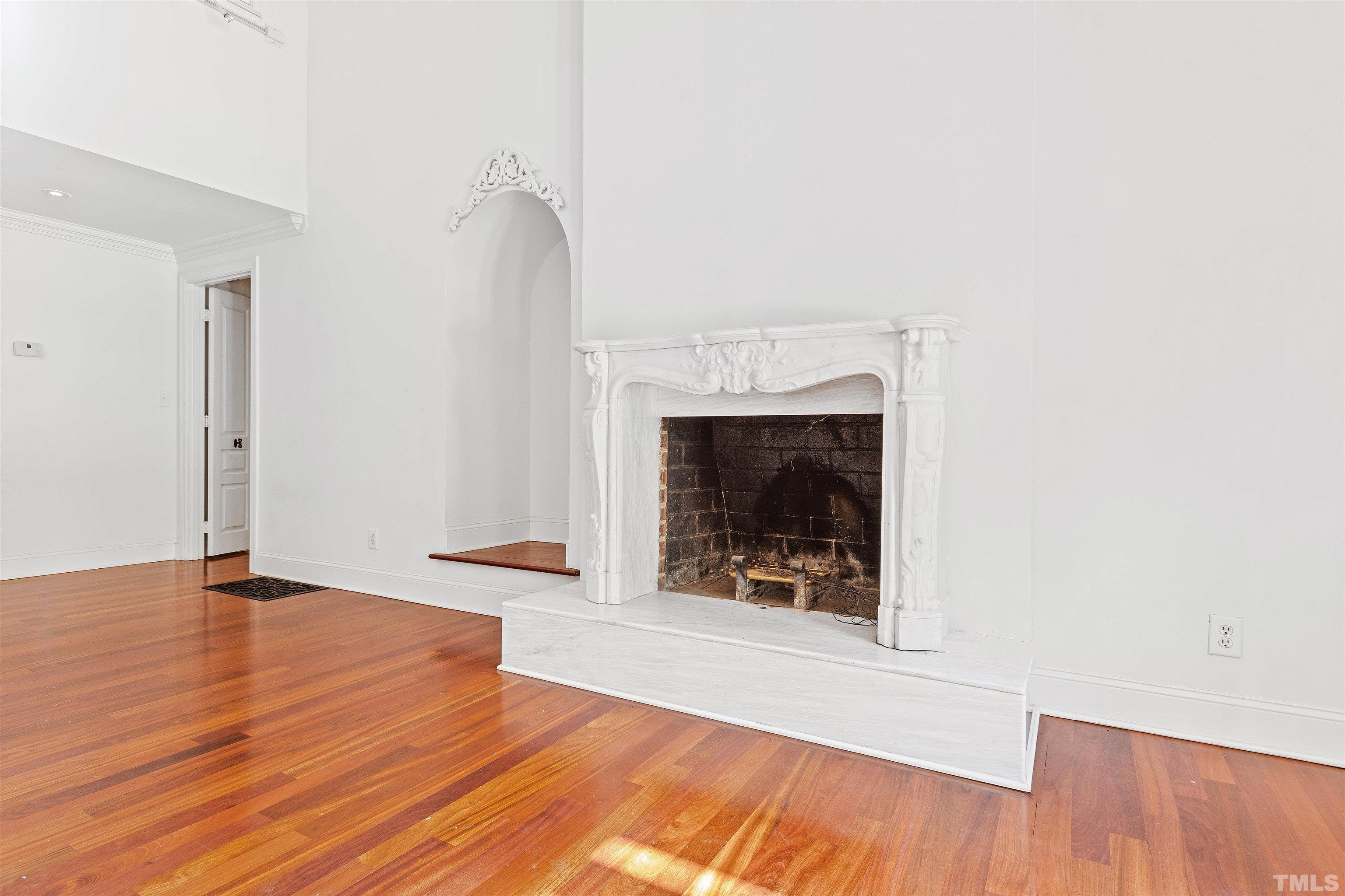 2429 Kirks Ridge Drive Raleigh, NC 27606 - Photo 24 of 65 an empty room with wooden floor and fireplace