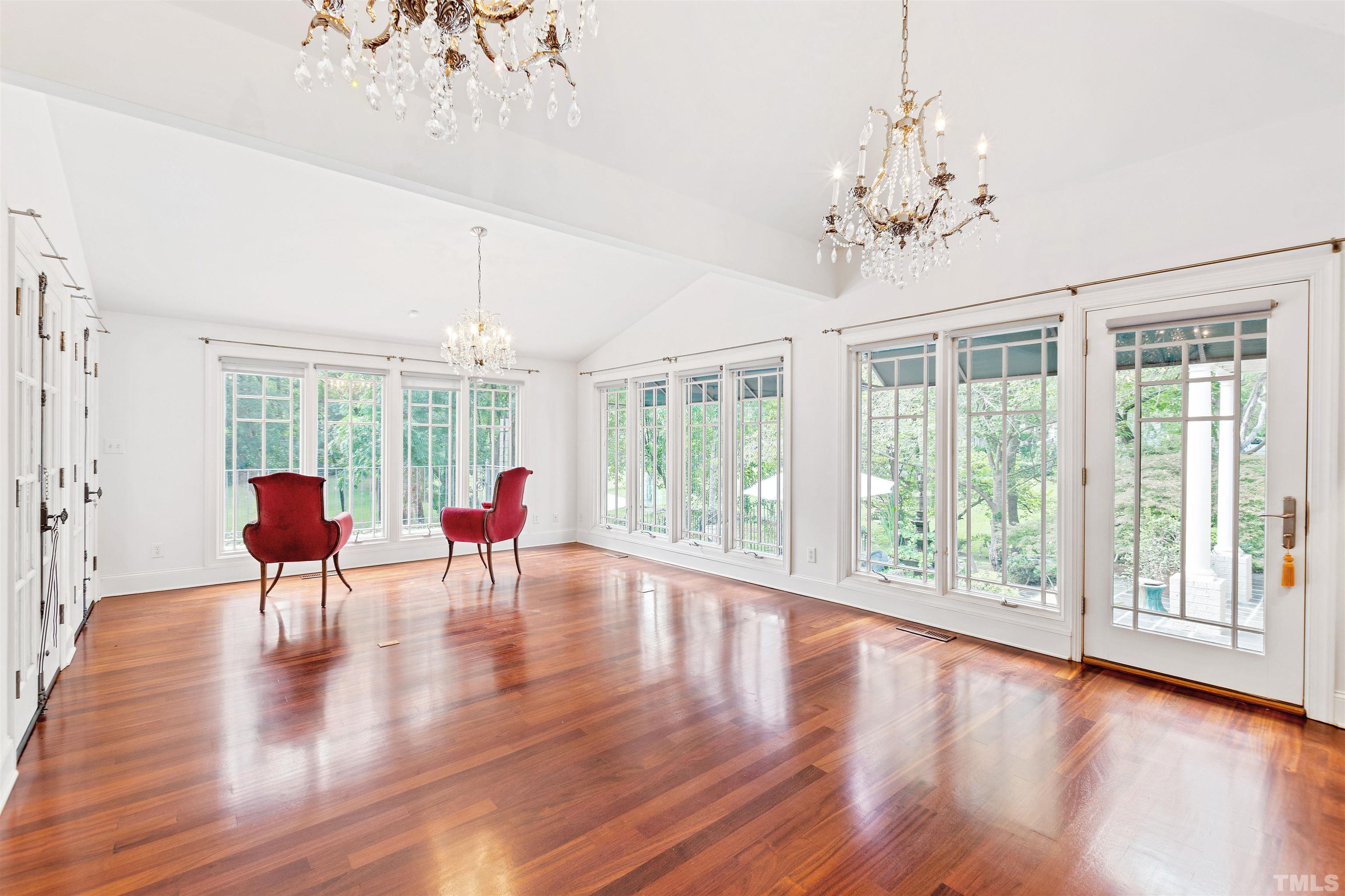 2429 Kirks Ridge Drive Raleigh, NC 27606 - Photo 35 of 65 a living room filled with furniture and a chandelier