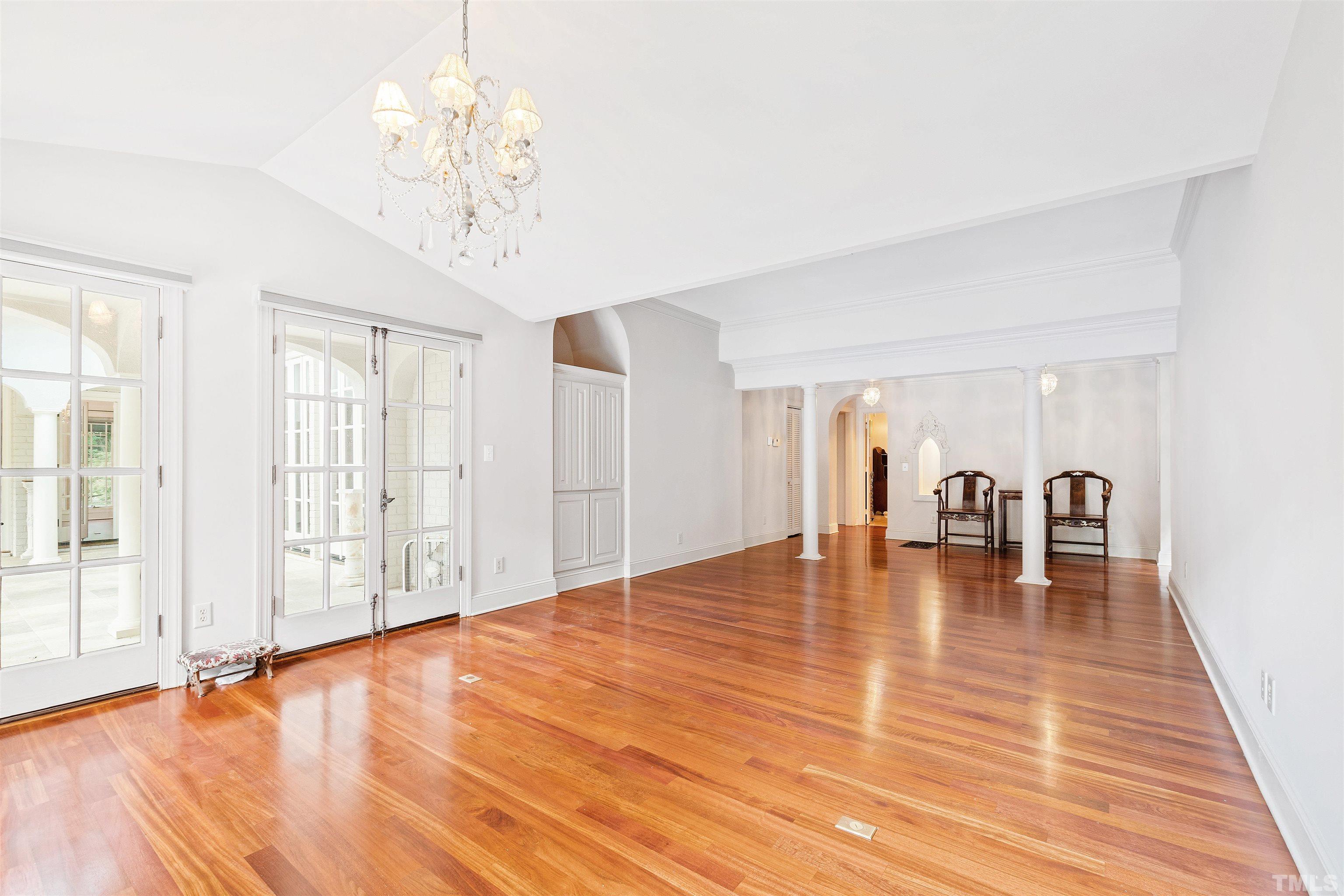 2429 Kirks Ridge Drive Raleigh, NC 27606 - Photo 41 of 65 a view of empty room with wooden floor and floor to ceiling window