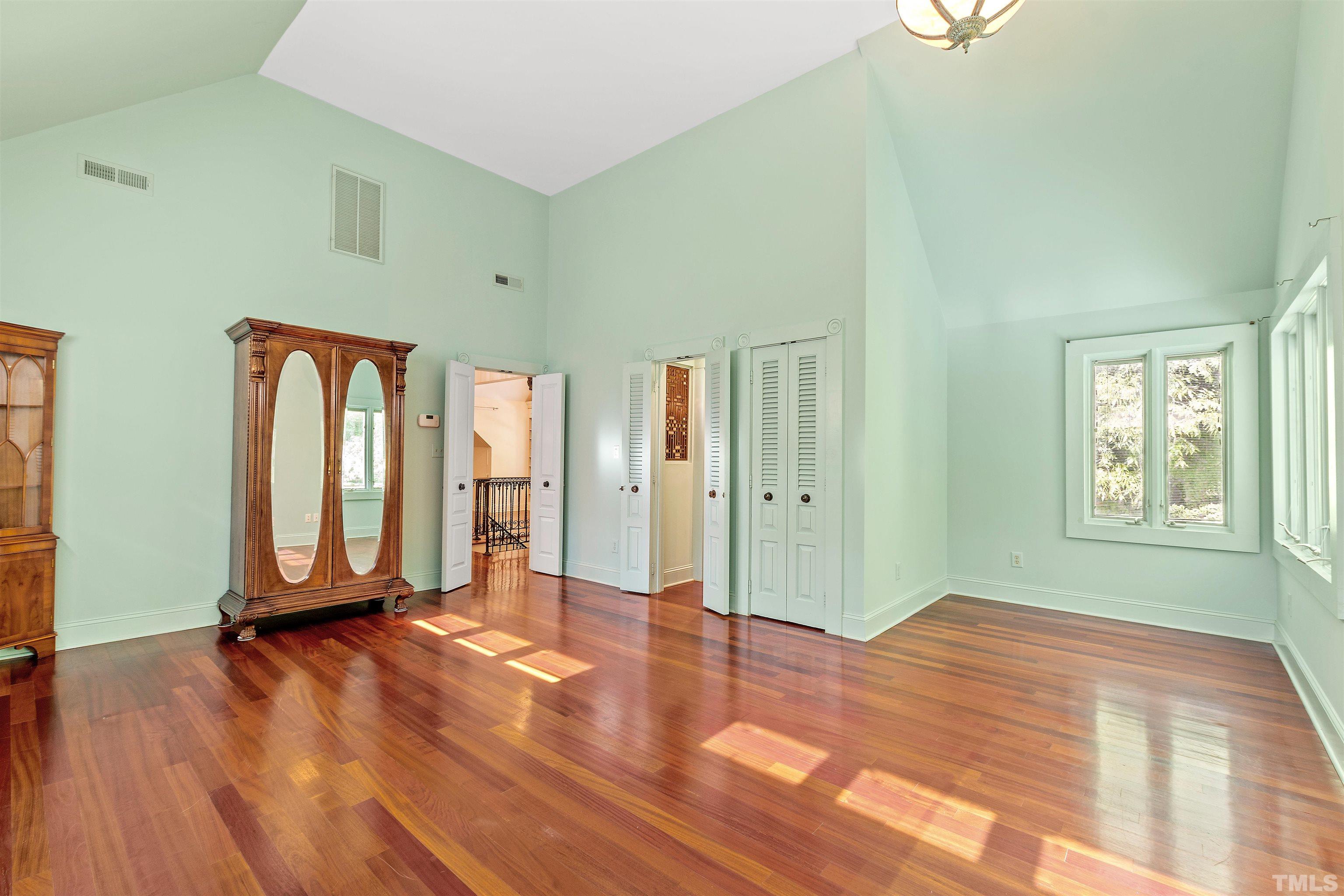2429 Kirks Ridge Drive Raleigh, NC 27606 - Photo 51 of 65 a view of an empty room with window and wooden floor