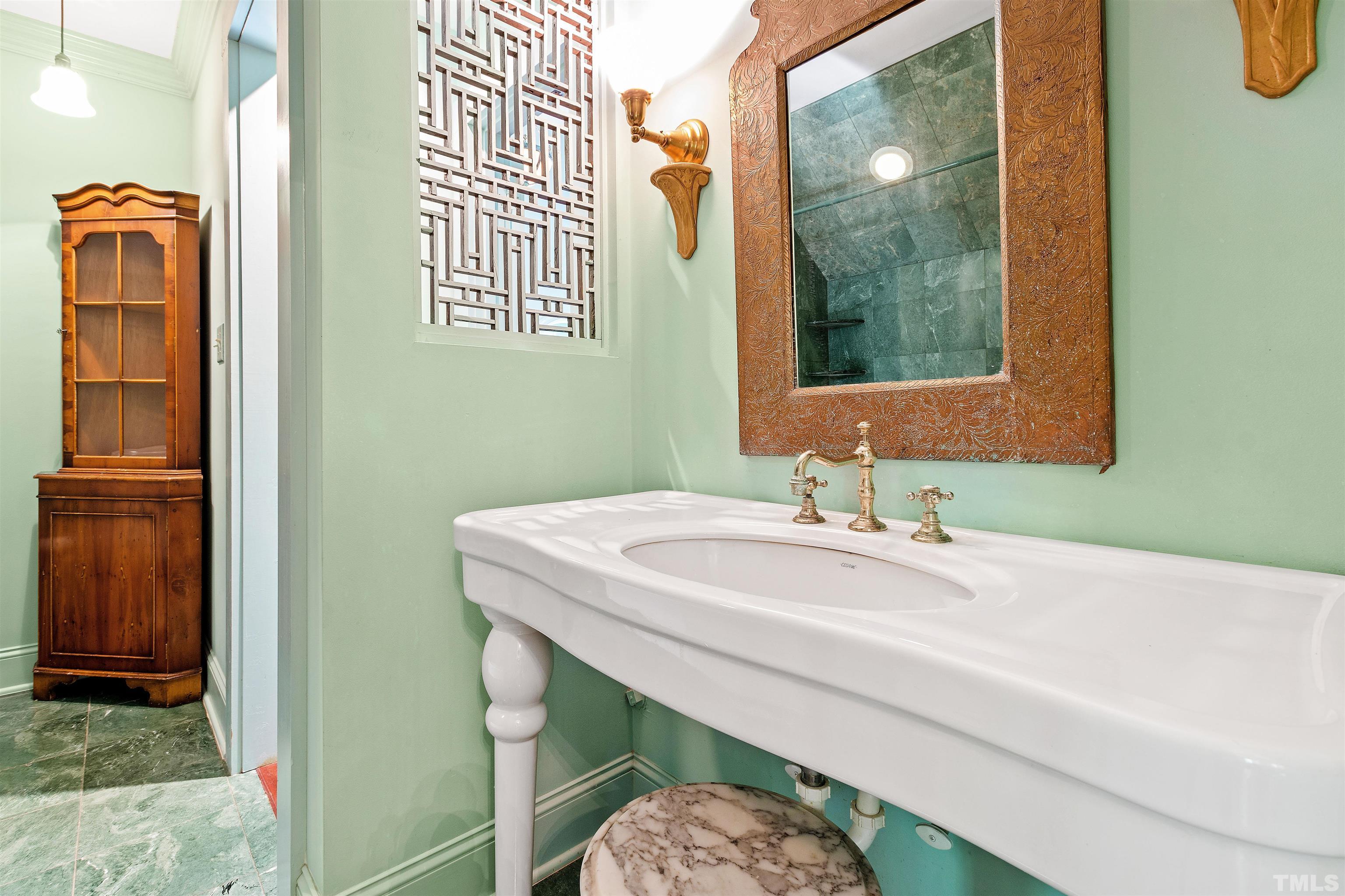 2429 Kirks Ridge Drive Raleigh, NC 27606 - Photo 54 of 65 a bathroom with a sink a mirror and a window