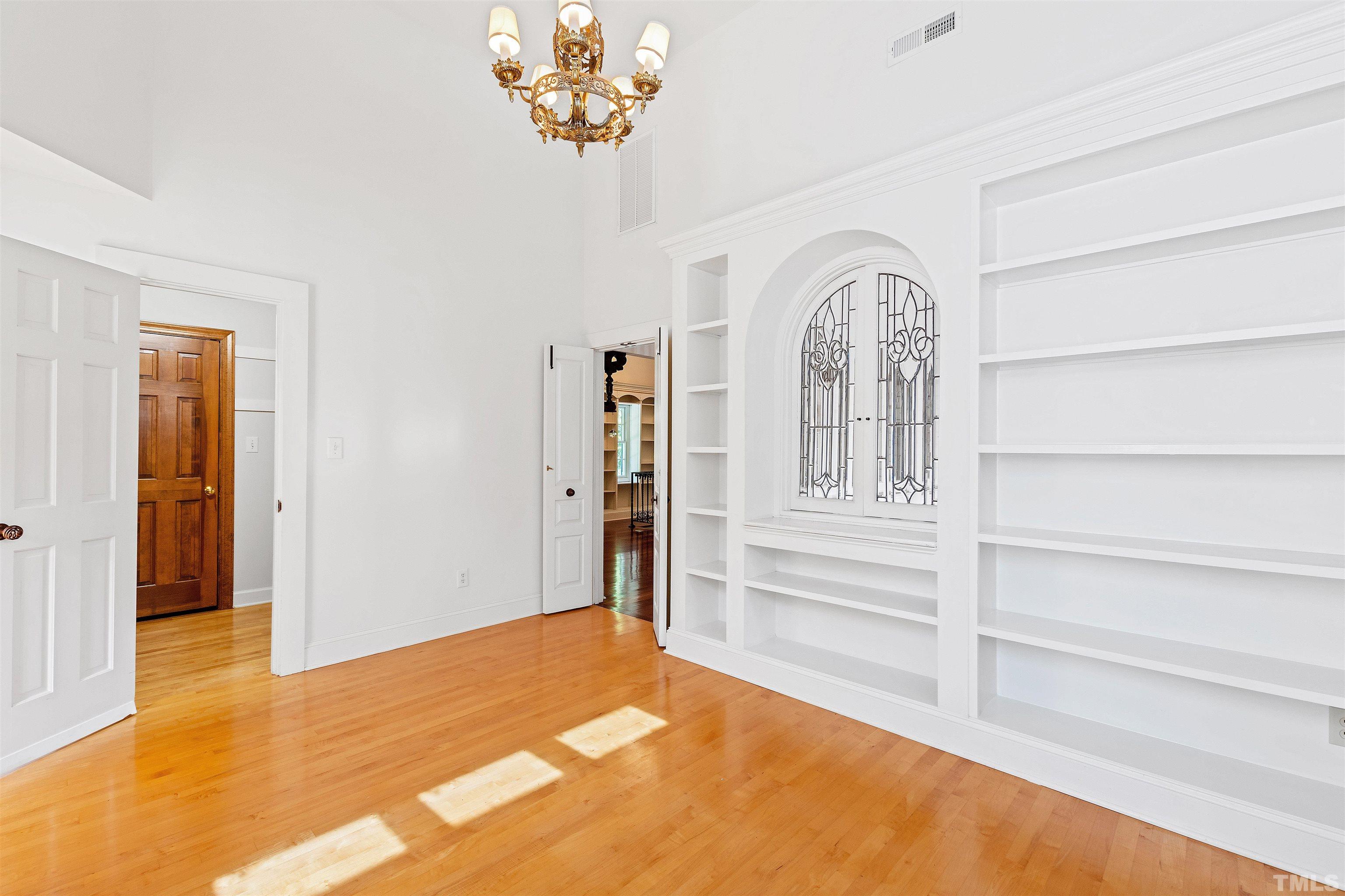 2429 Kirks Ridge Drive Raleigh, NC 27606 - Photo 56 of 65 a view of a bedroom with wooden floor and a window