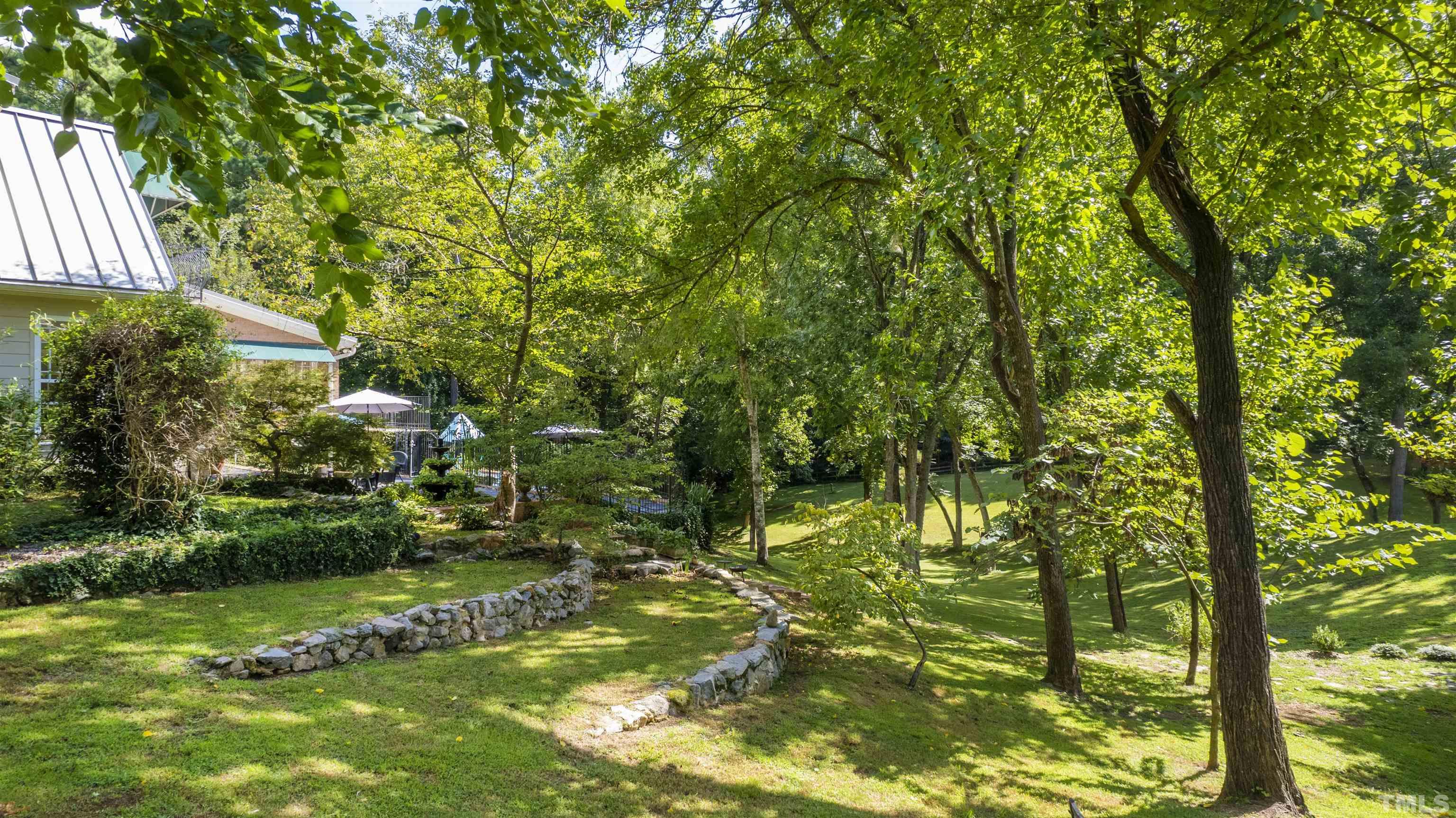 2429 Kirks Ridge Drive Raleigh, NC 27606 - Photo 64 of 65 a backyard of a house with lots of green space