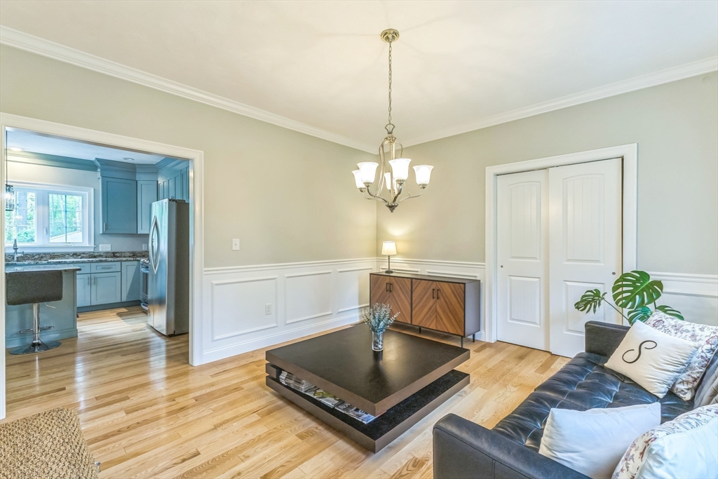 82 Sutton Street Uxbridge, MA 01569 - Photo 12 of 31 a living room with furniture and a chandelier
