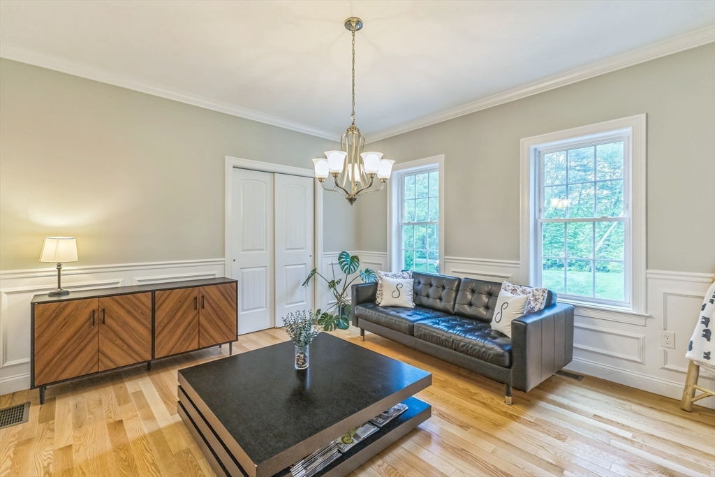 82 Sutton Street Uxbridge, MA 01569 - Photo 13 of 31 a living room with furniture and a chandelier