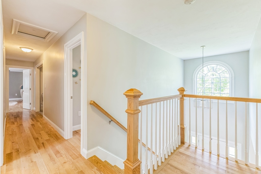 82 Sutton Street Uxbridge, MA 01569 - Photo 14 of 31 a view of a hallway with wooden floor windows and a chandelier