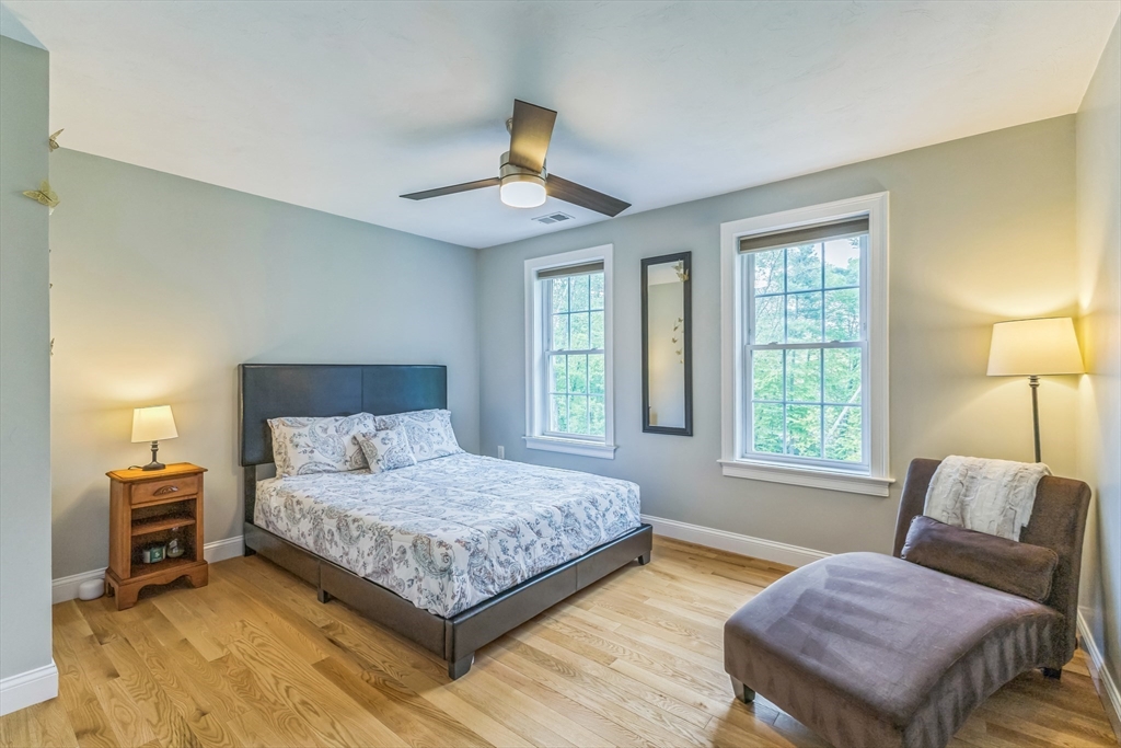 82 Sutton Street Uxbridge, MA 01569 - Photo 15 of 31 a bedroom with a bed and wooden floor