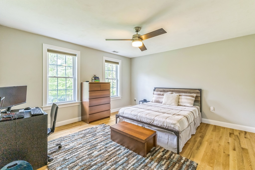 82 Sutton Street Uxbridge, MA 01569 - Photo 16 of 31 a bedroom with a bed and wooden floor