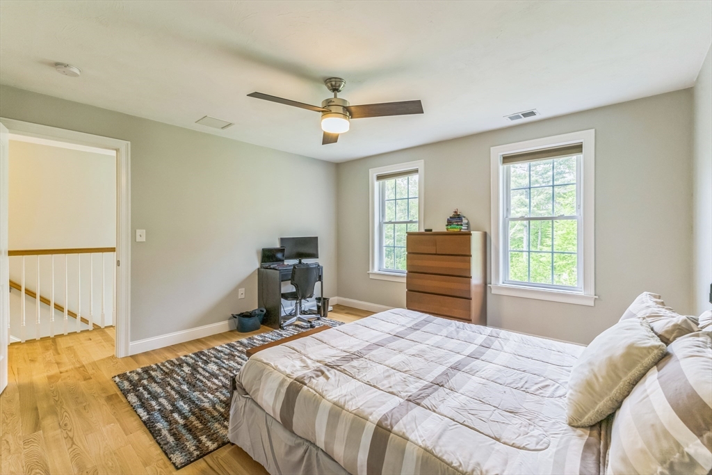 82 Sutton Street Uxbridge, MA 01569 - Photo 17 of 31 a bedroom with a bed and a chair with the wooden floor