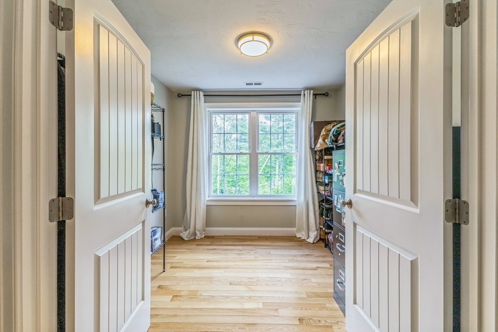 82 Sutton Street Uxbridge, MA 01569 - Photo 24 of 31 a view of a hallway with wooden floor and windows