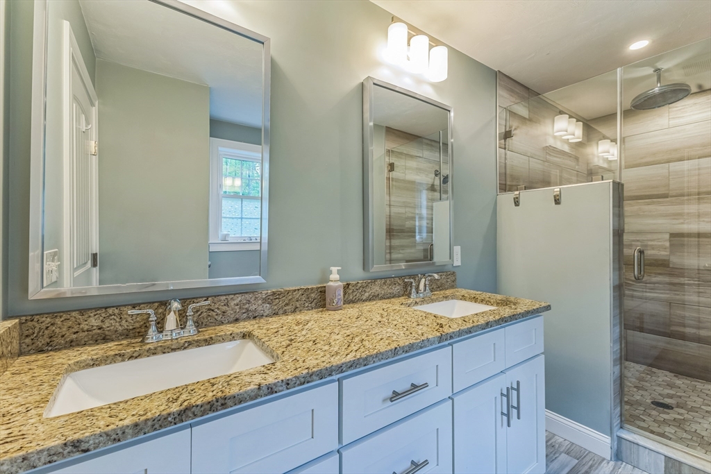 82 Sutton Street Uxbridge, MA 01569 - Photo 25 of 31 a bathroom with a granite countertop double vanity sink and a mirror