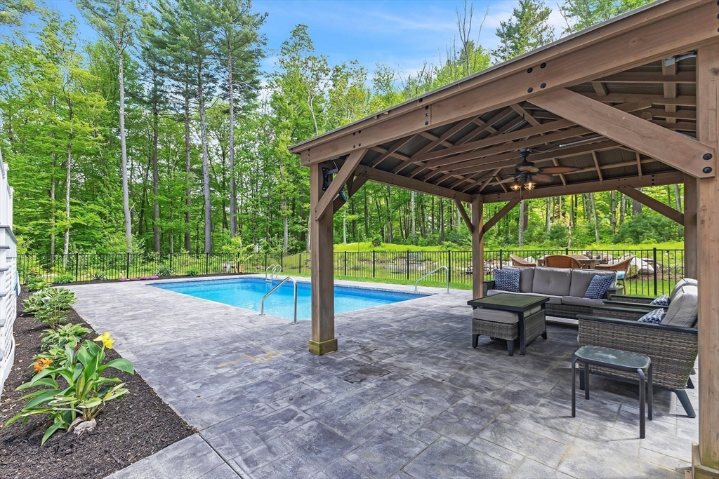 82 Sutton Street Uxbridge, MA 01569 - Photo 28 of 31 a view of a patio with a table chairs and a backyard