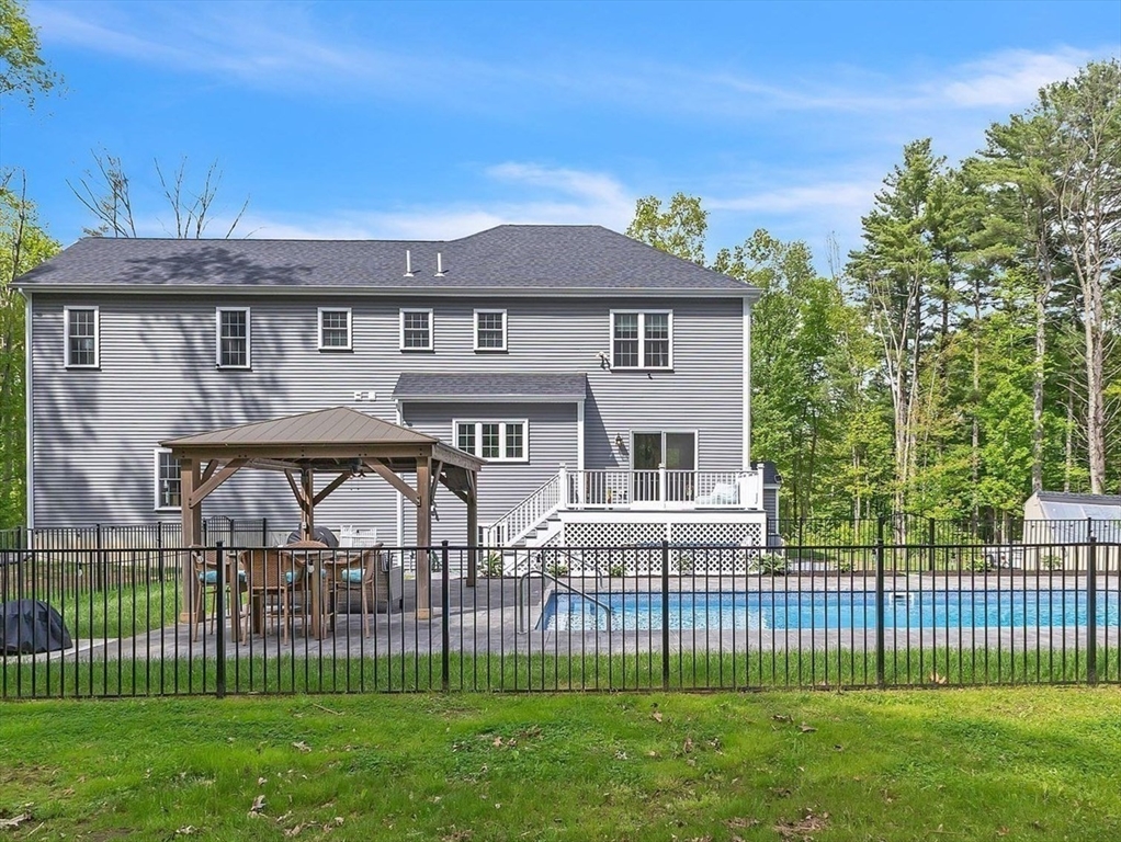 82 Sutton Street Uxbridge, MA 01569 - Photo 30 of 31 a view of a house with a small yard and a garden