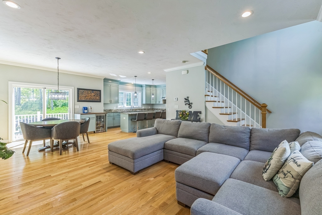 82 Sutton Street Uxbridge, MA 01569 - Photo 4 of 31 a living room with furniture kitchen view and a wooden floor