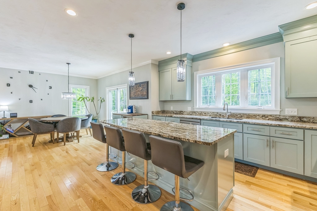 82 Sutton Street Uxbridge, MA 01569 - Photo 7 of 31 a kitchen with center island table and chairs