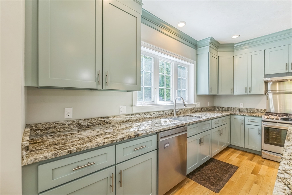 82 Sutton Street Uxbridge, MA 01569 - Photo 8 of 31 a kitchen with granite countertop stainless steel appliances white cabinets granite counter tops and a window