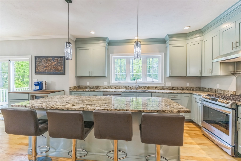 82 Sutton Street Uxbridge, MA 01569 - Photo 9 of 31 a kitchen with granite countertop a stove a sink and a refrigerator