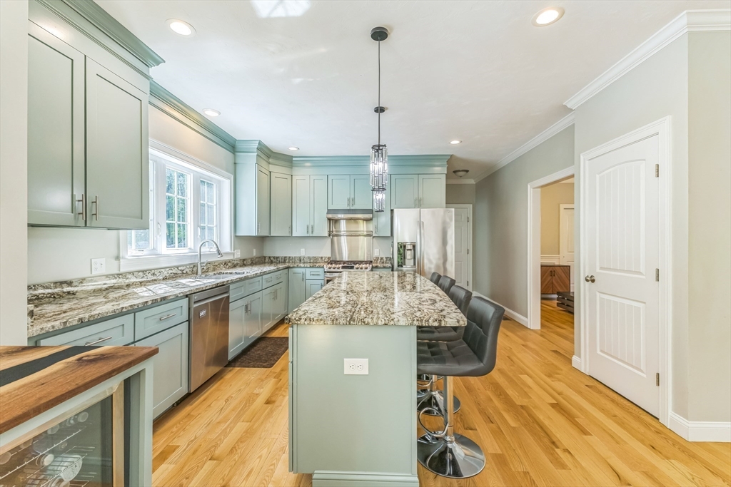 82 Sutton Street Uxbridge, MA 01569 - Photo 10 of 31 a kitchen with stainless steel appliances granite countertop a sink refrigerator and cabinets