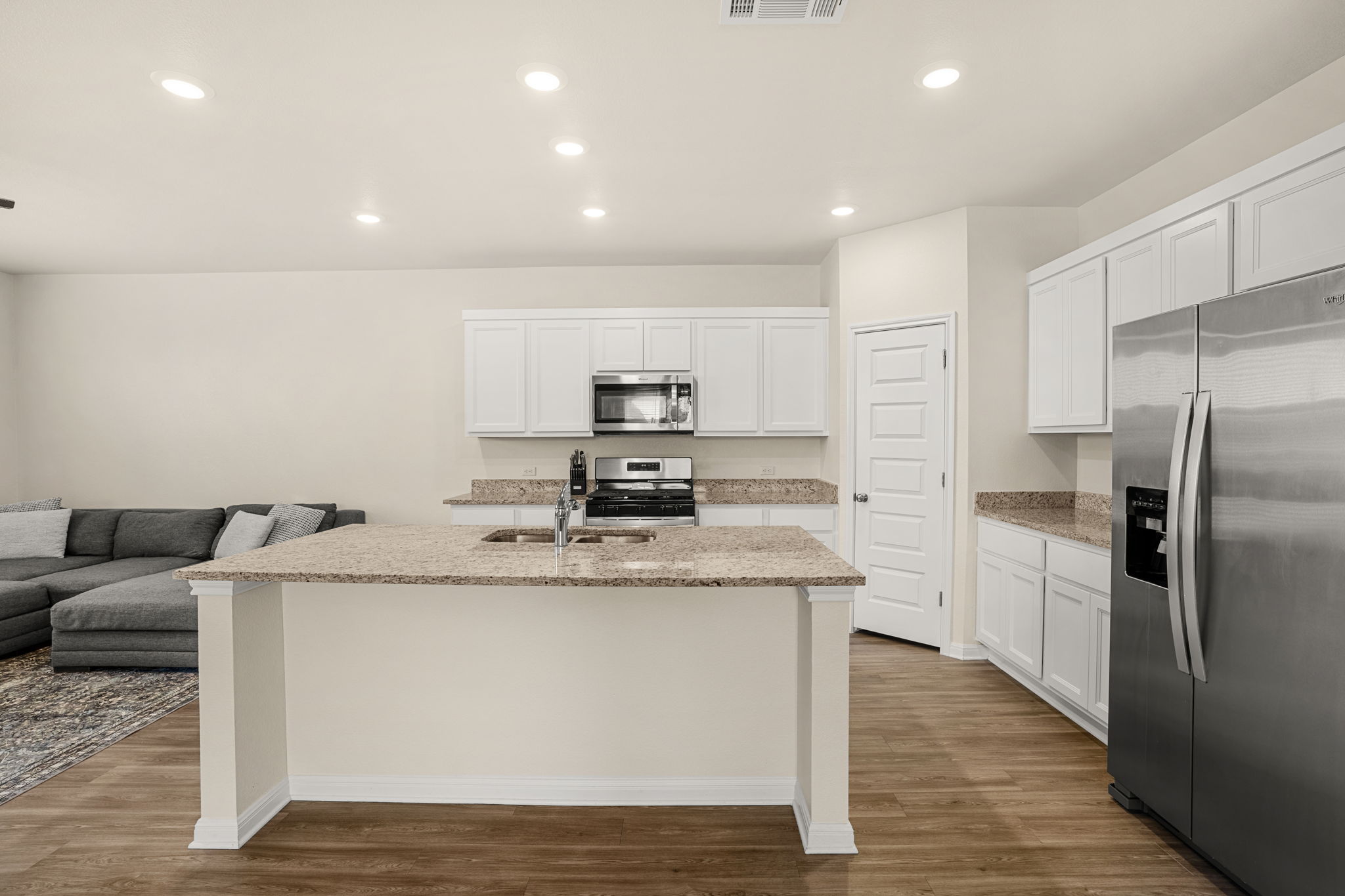 148 Hidalgo Lane Elgin, TX 78621 - Photo 11 of 38 An open concept kitchen features abundant counter space and modern stainless steel appliances.