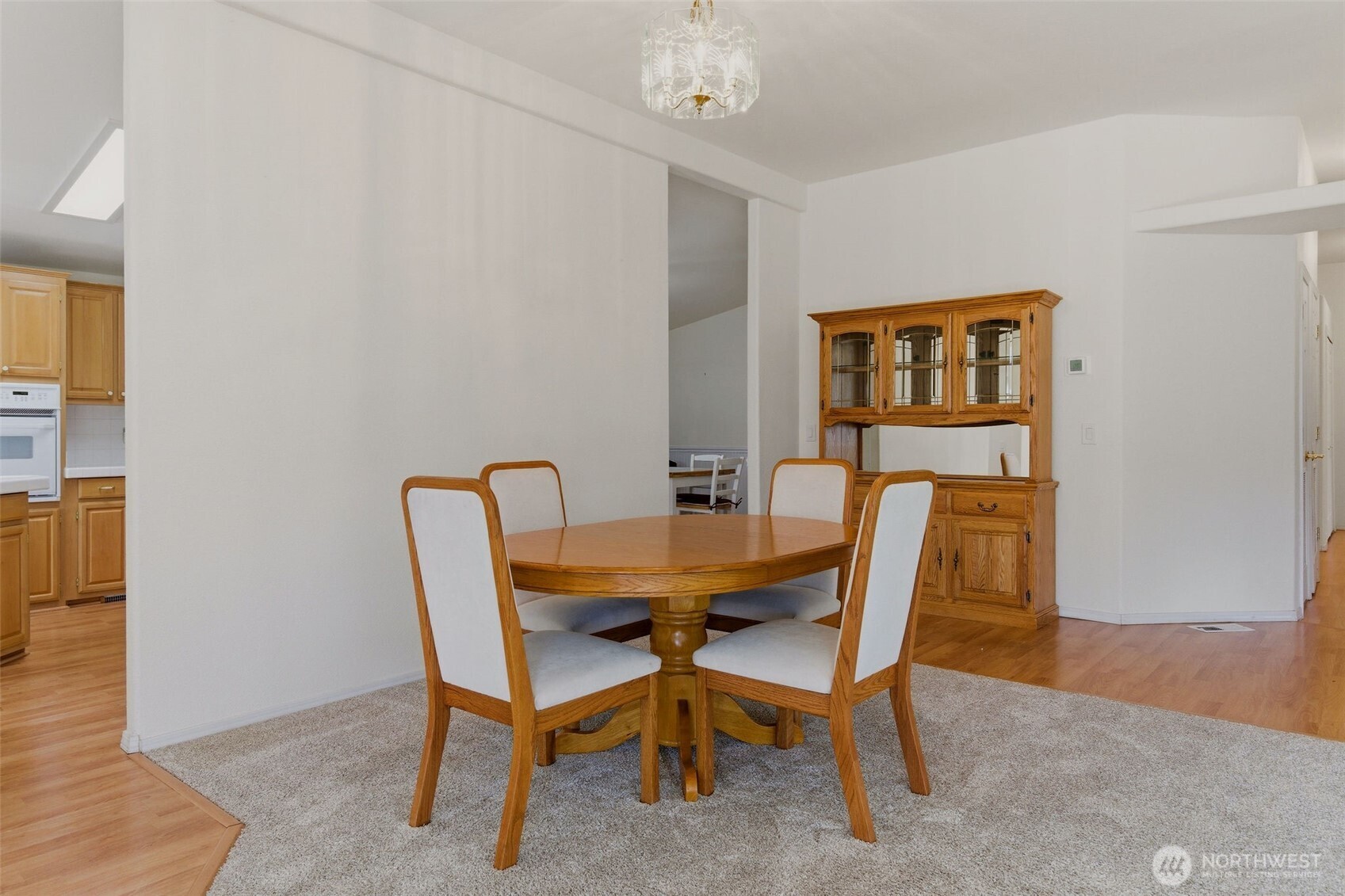 24036 222nd Avenue Southeast Maple Valley, WA 98038 - Photo 8 of 37 a view of a dining room with furniture and wooden floor