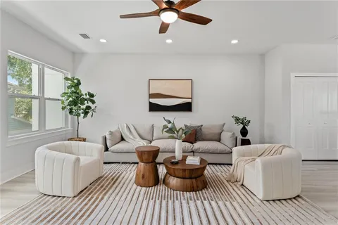 a living room with furniture and a potted plant