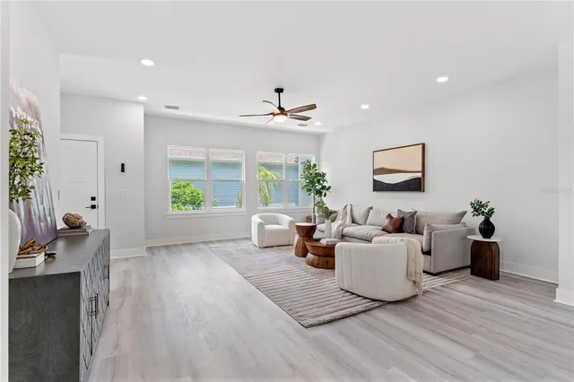 a living room with furniture window and wooden floor