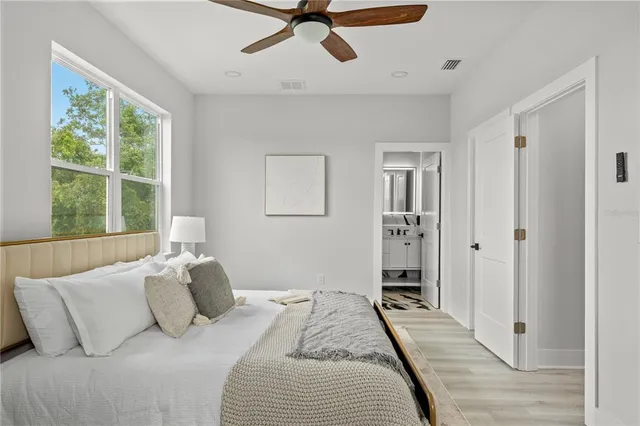 a bedroom with a bed and a window