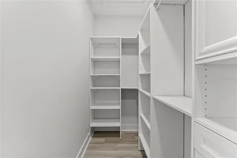 a view of walk in closet with empty racks
