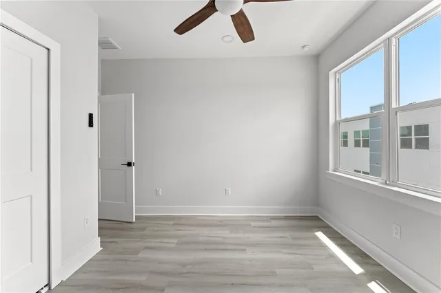 wooden floor in an empty room with a window