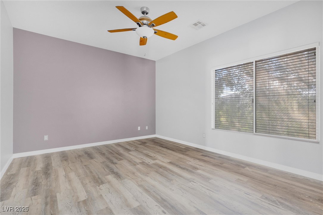 9617 Sharp Horn Court Las Vegas, NV 89149 - Photo 11 of 27 Spare room featuring a ceiling fan, light wood-style floors, baseboards, and visible vents