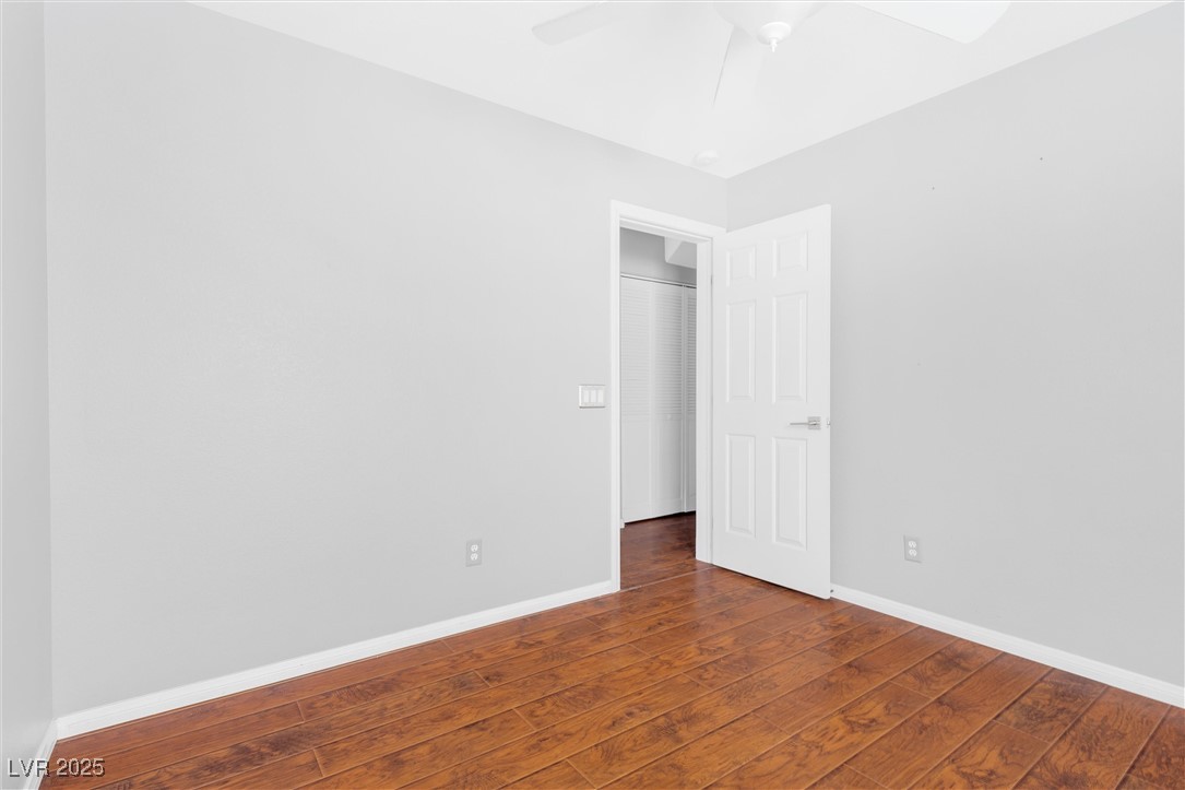 9617 Sharp Horn Court Las Vegas, NV 89149 - Photo 15 of 27 Spare room featuring baseboards, a ceiling fan, and hardwood / wood-style flooring