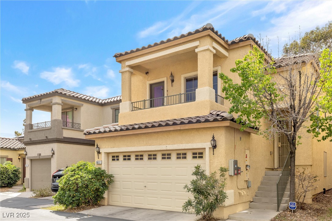 9617 Sharp Horn Court Las Vegas, NV 89149 - Photo 2 of 27 Mediterranean / spanish home with a tile roof, stucco siding, and an attached garage