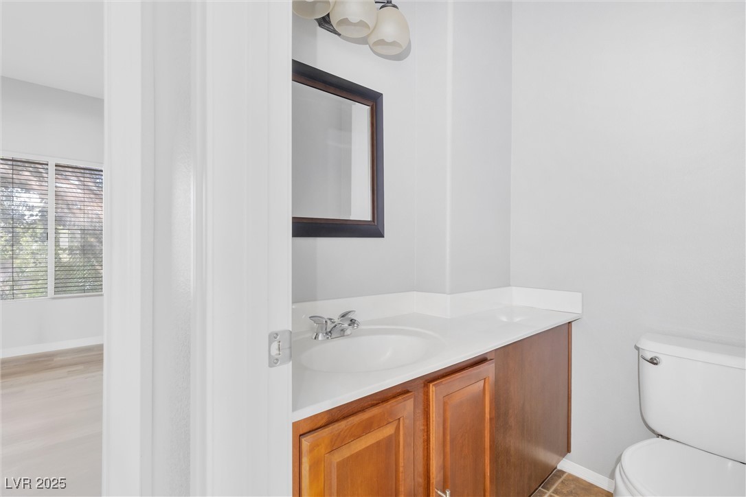 9617 Sharp Horn Court Las Vegas, NV 89149 - Photo 21 of 27 Bathroom featuring baseboards, toilet, and vanity