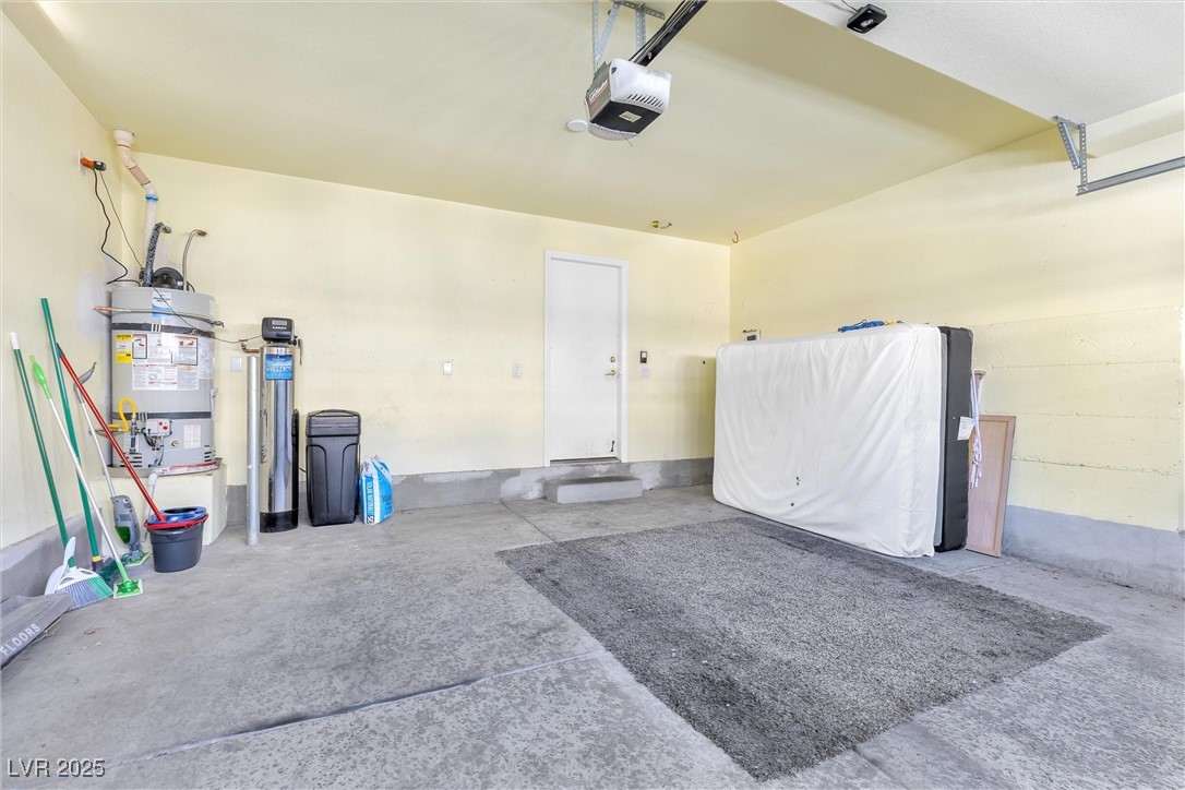 9617 Sharp Horn Court Las Vegas, NV 89149 - Photo 23 of 27 Garage featuring a garage door opener and secured water heater