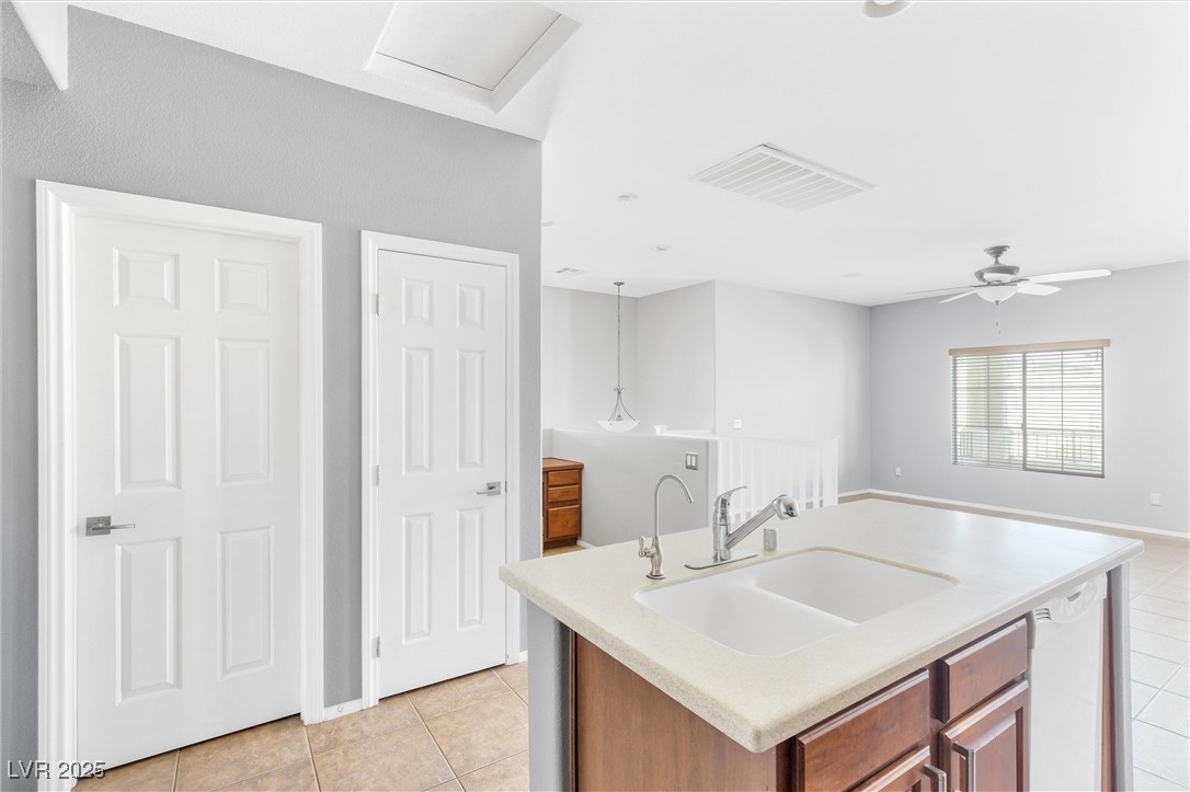 9617 Sharp Horn Court Las Vegas, NV 89149 - Photo 7 of 27 Kitchen with light countertops, visible vents, a sink, white dishwasher, and light tile patterned floors