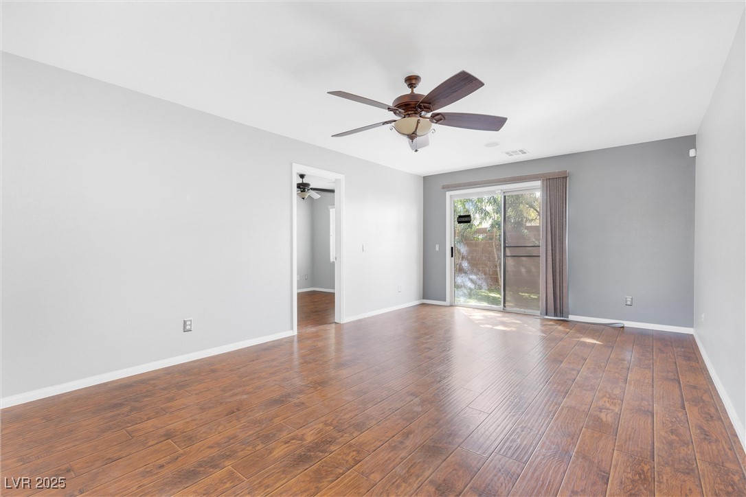9617 Sharp Horn Court Las Vegas, NV 89149 - Photo 9 of 27 Empty room featuring visible vents, baseboards, ceiling fan, and wood finished floors